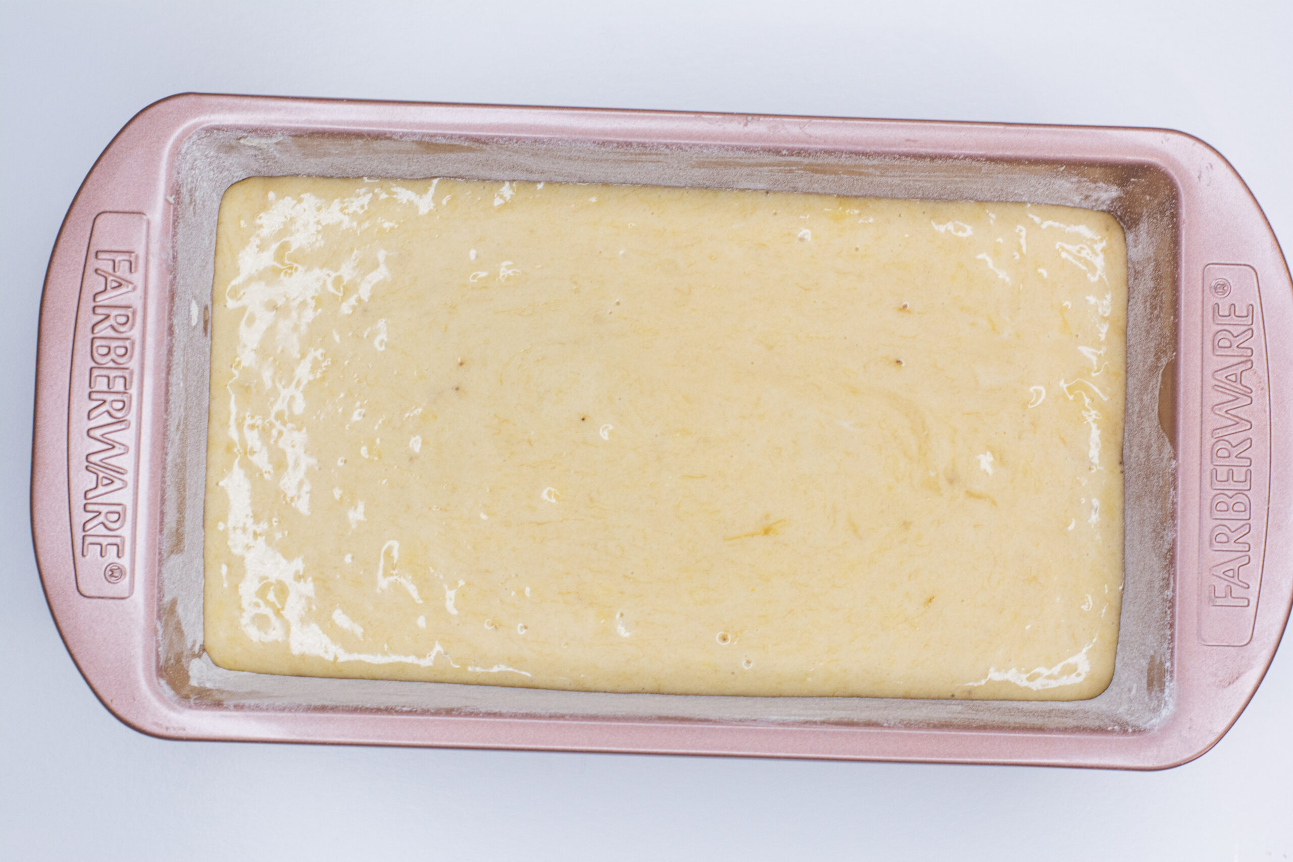 Banana bread batter in a bread loaf pan.