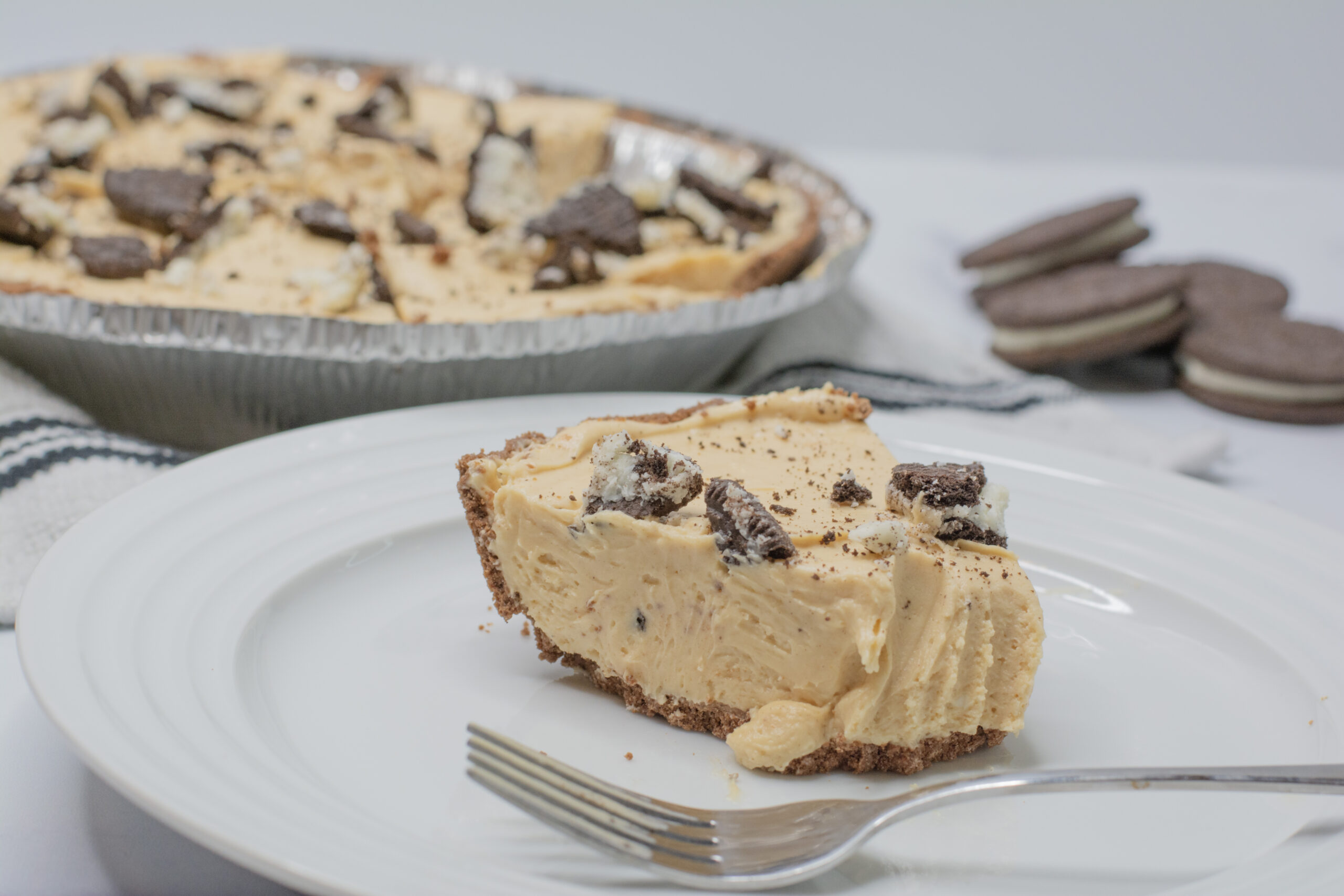 A bite taken out of a slice of peanut butter pie.