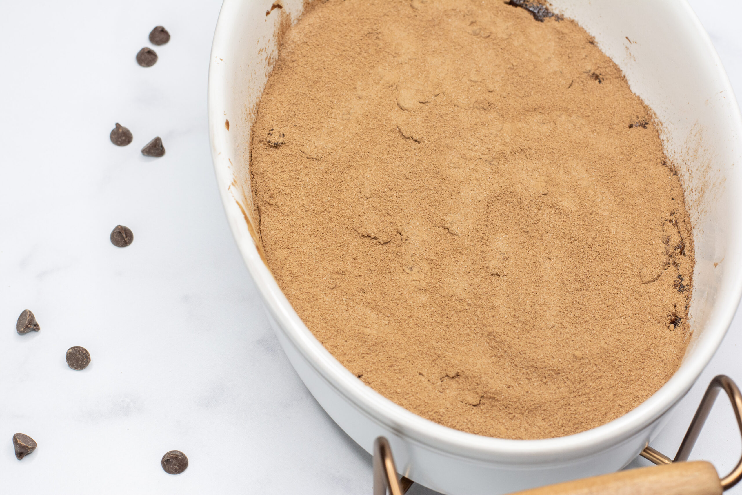 Cocoa sprinkled on cake in a pan.