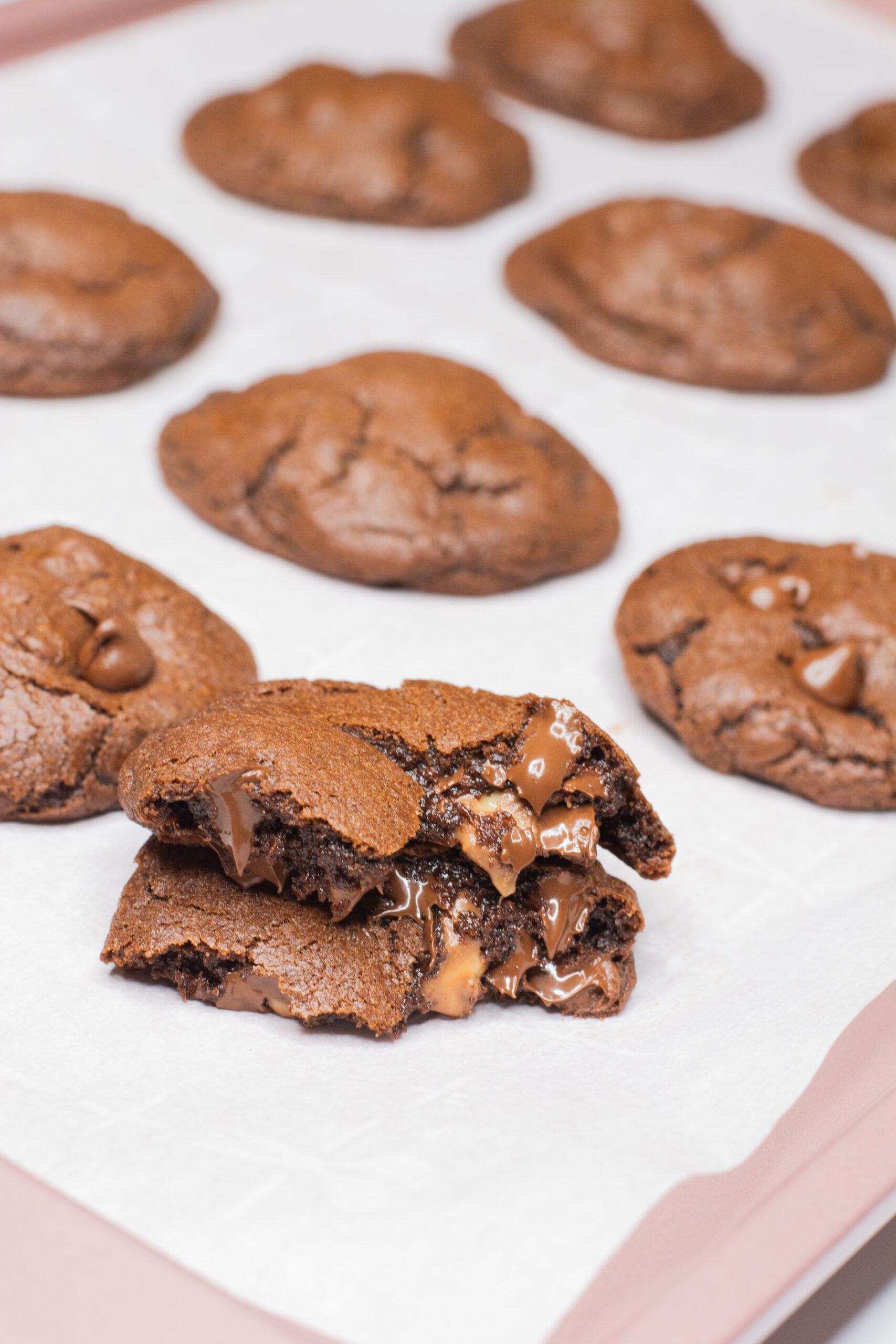 Close up picture of chocolate melting in chocolate rolo cookies with caramel seeping out of the cookie.