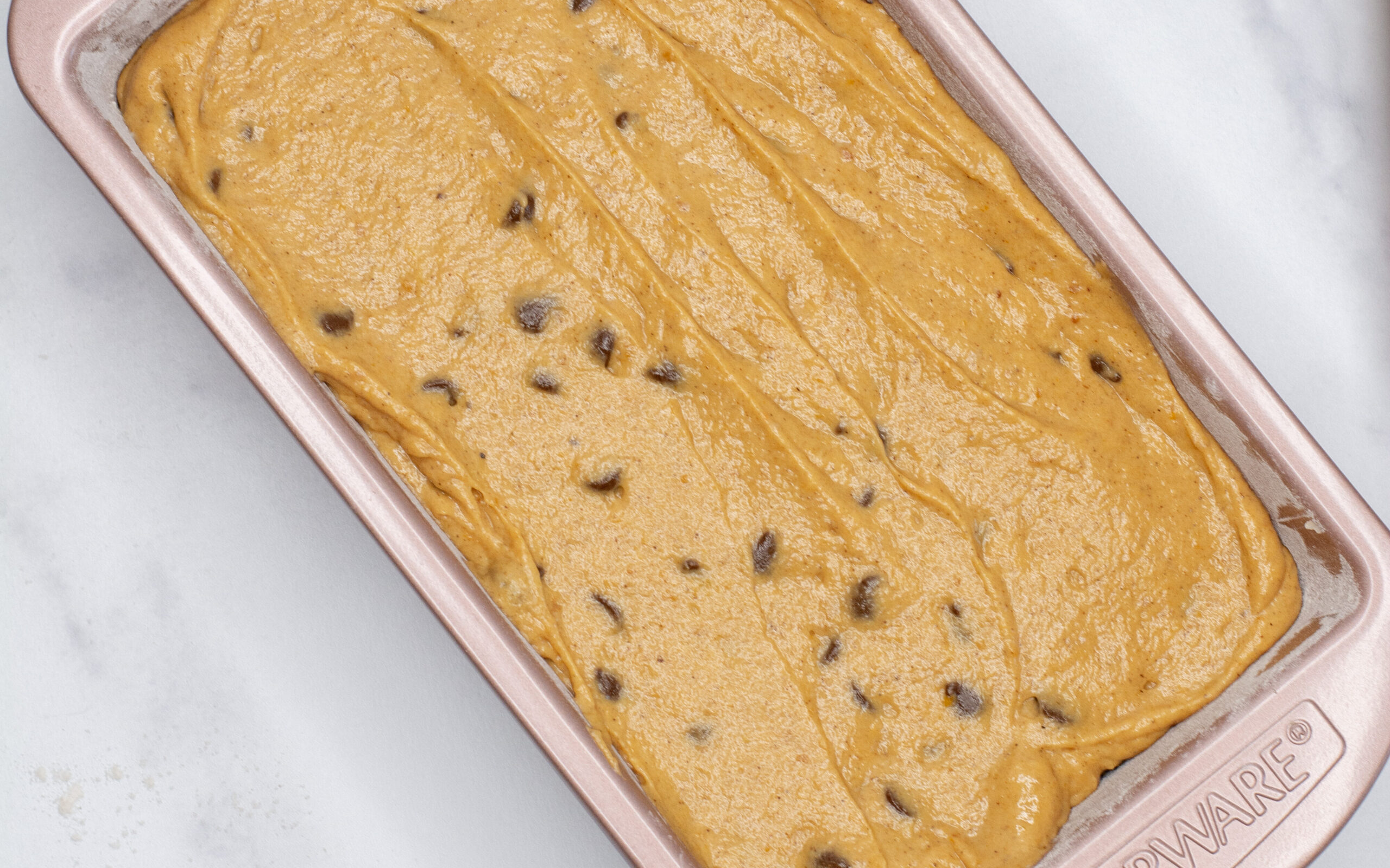 Pumpkin chocolate chip bread batter in a loaf pan.