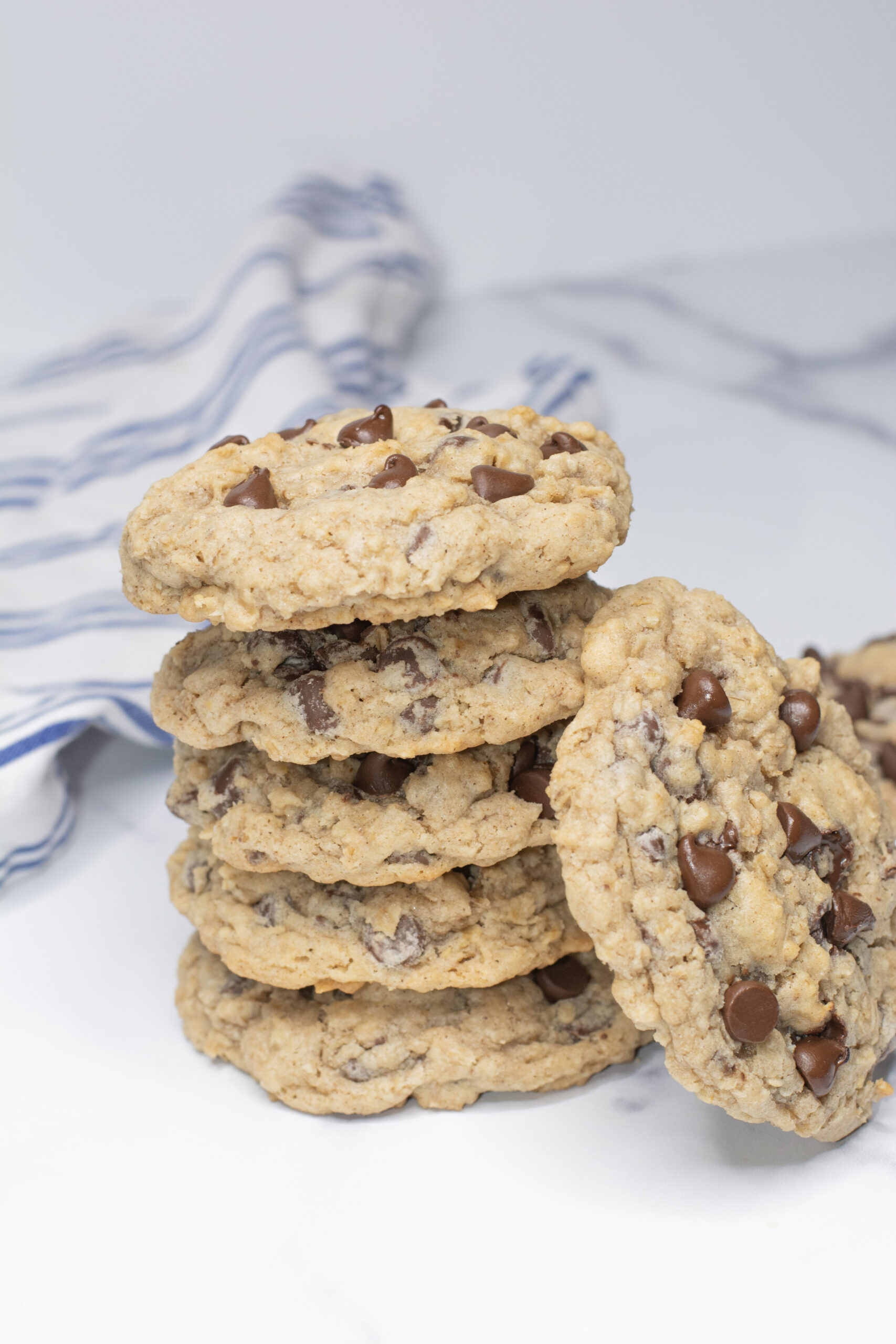 Oatmeal Chocolate Chip Cookies stacked on top of each other on the counter