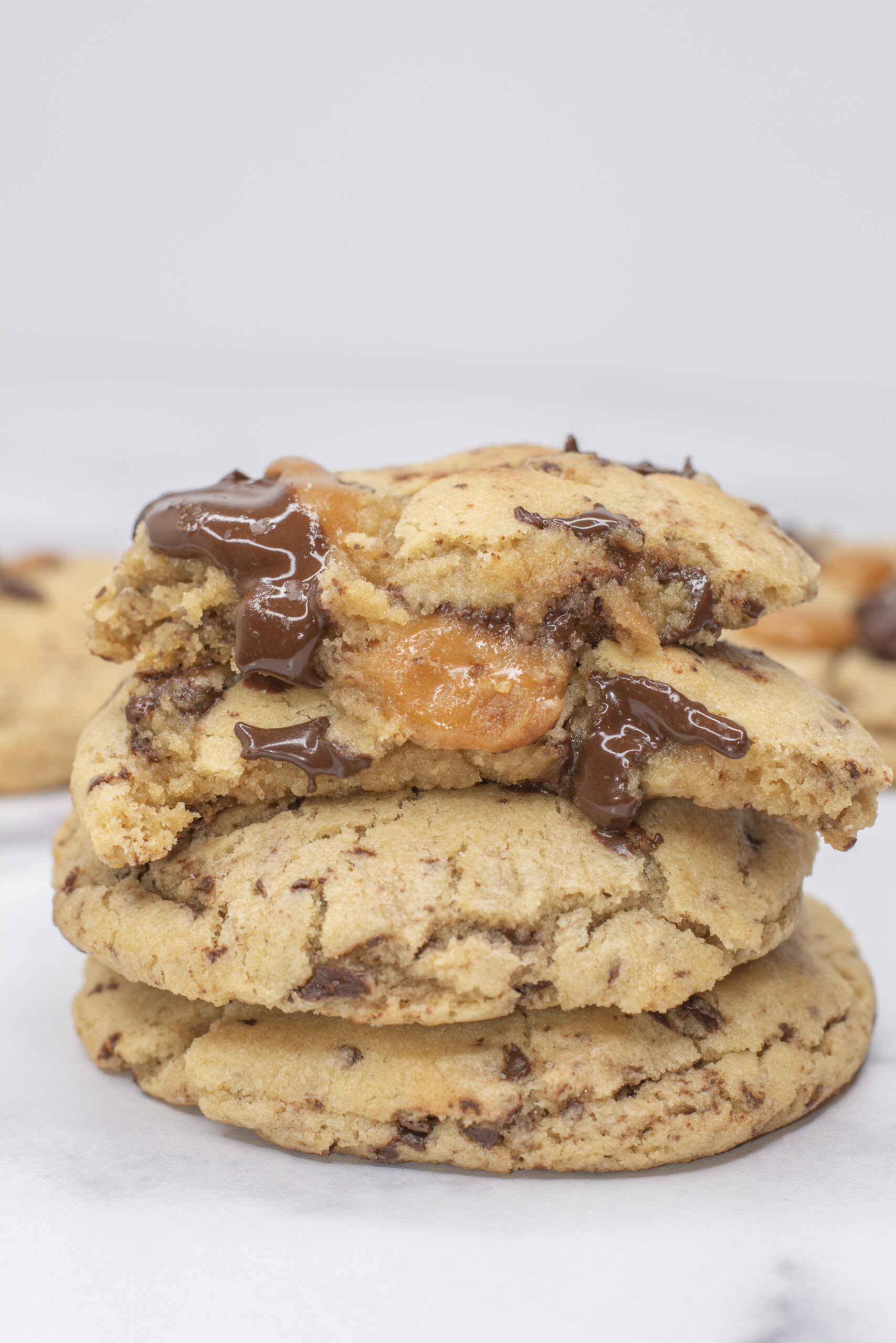 Four salted caramel cookies stacked on top of each other.