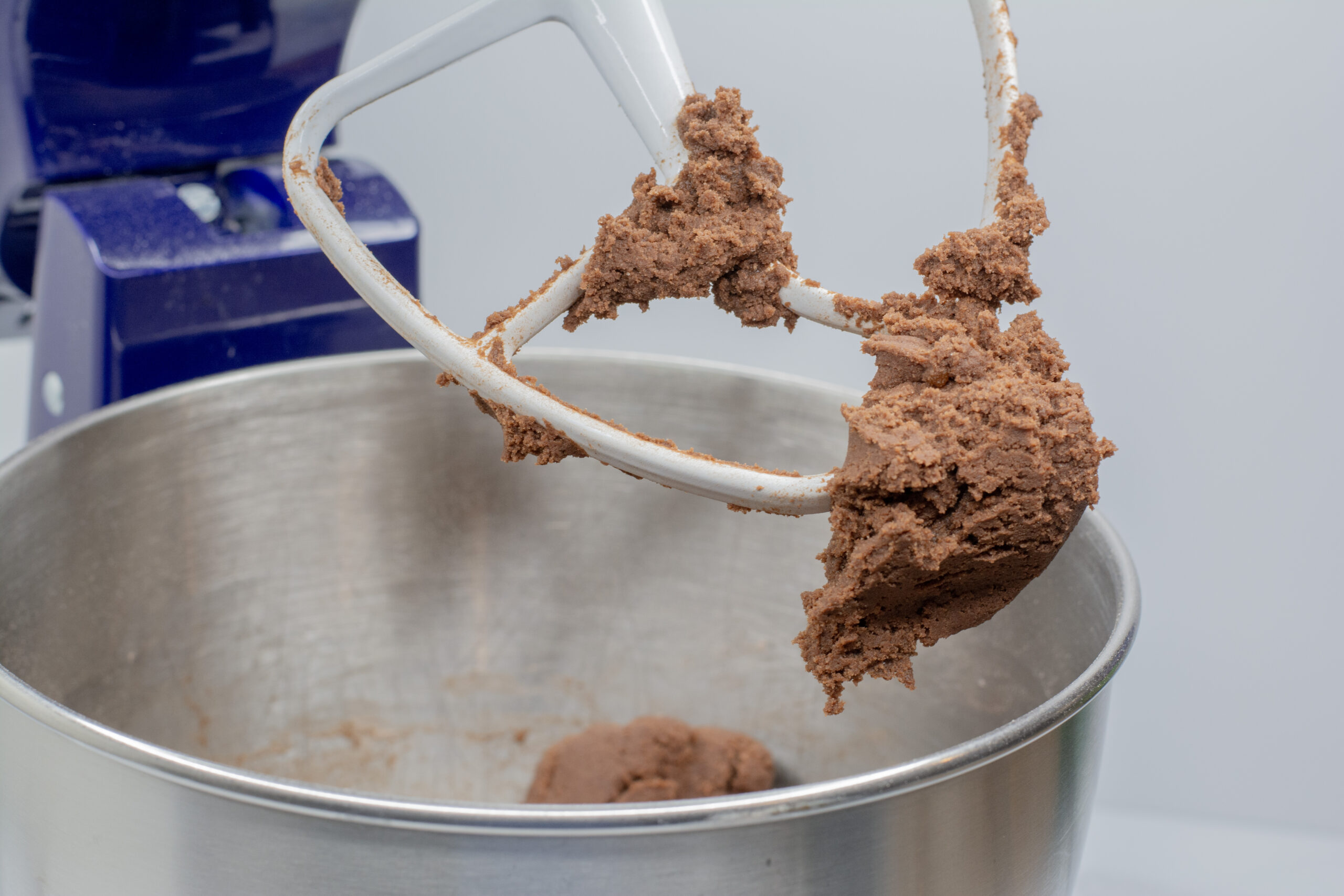 Chocolate pudding cookies cookie dough in Kitchen Aid mixer.
