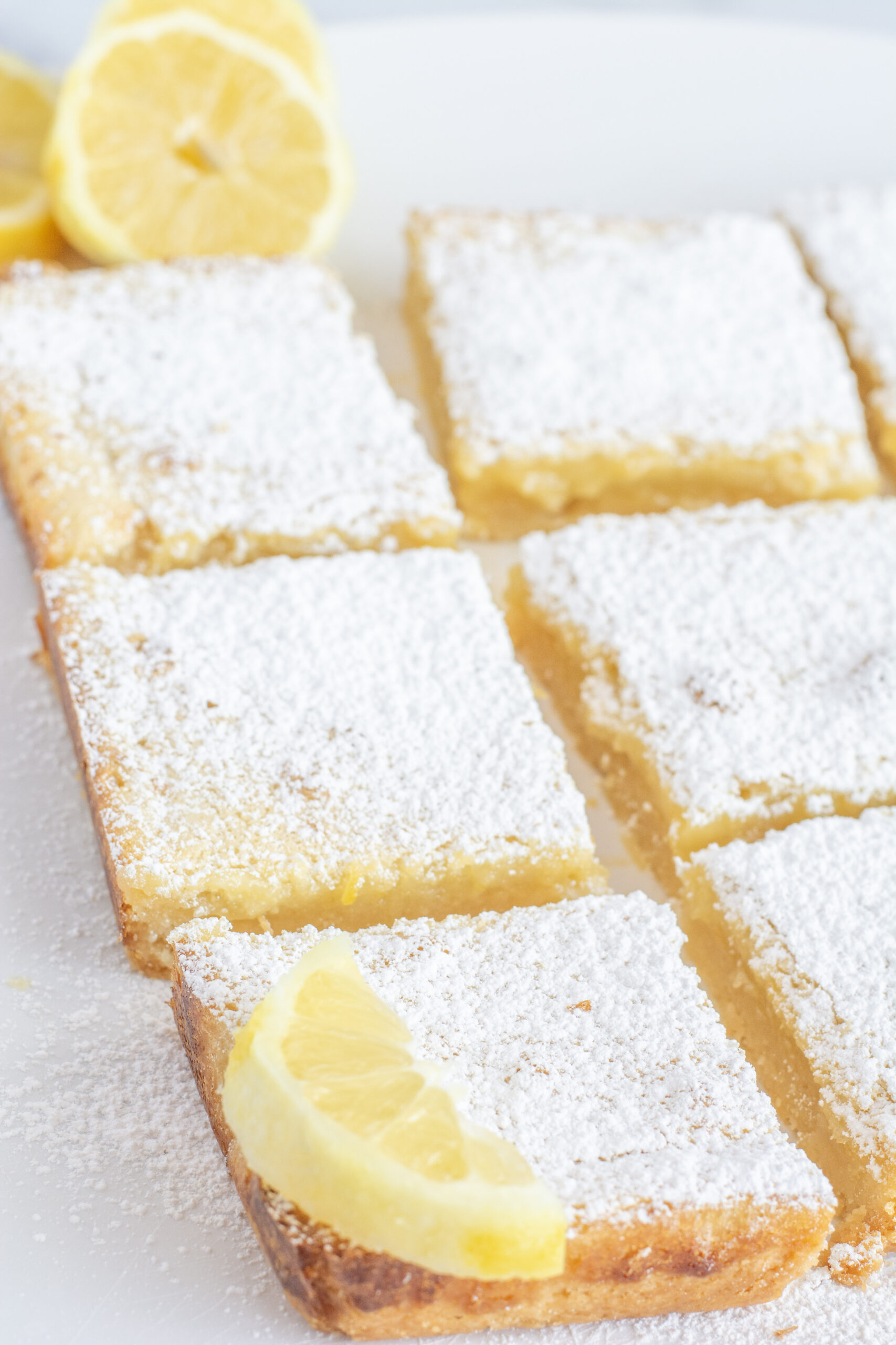 Tangy lemon bars sliced into pieces.