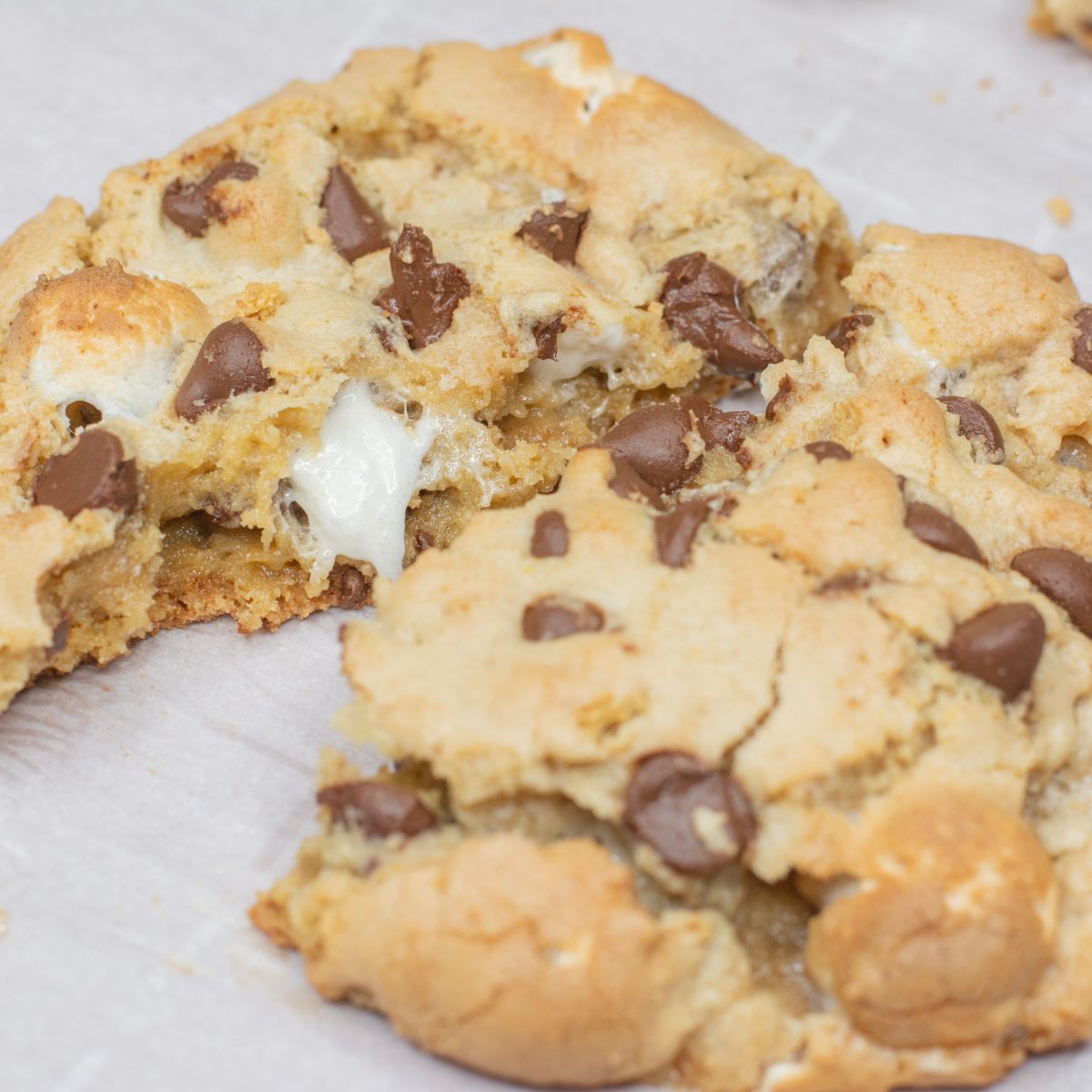 Marshmallows and chocolate oozing out of a large cookie