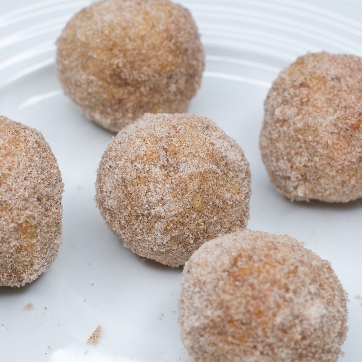Banana Cinnamon Donut Holes on a plate.