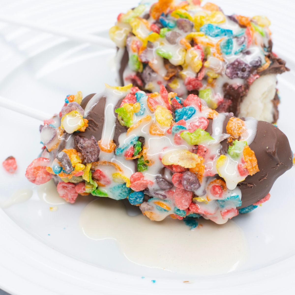Chocolate covered frozen banana with sprinkle toppings and marshmallows