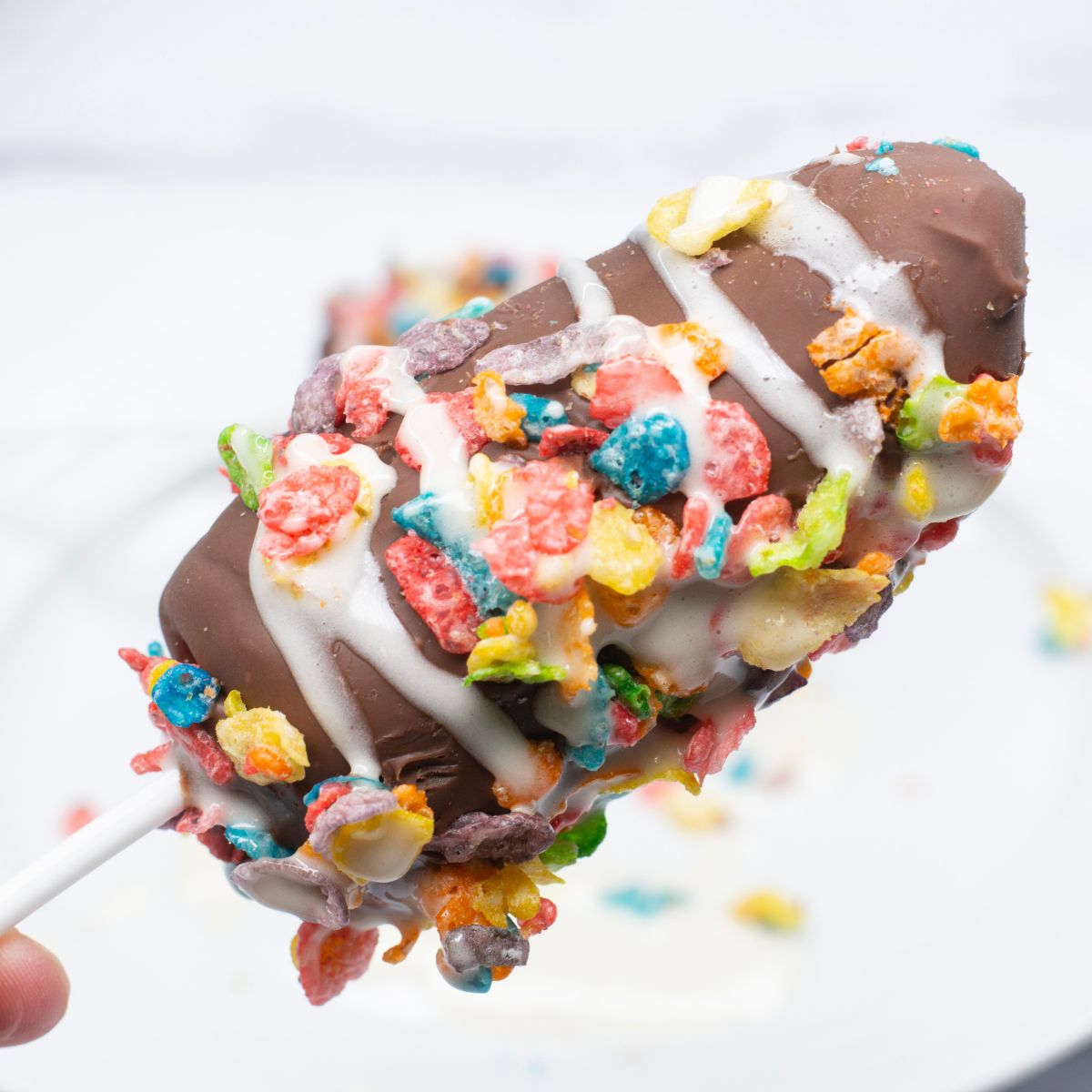 Frozen Banana Popsicle with Fruity Dyno-Bites & Marshmallow Drizzle