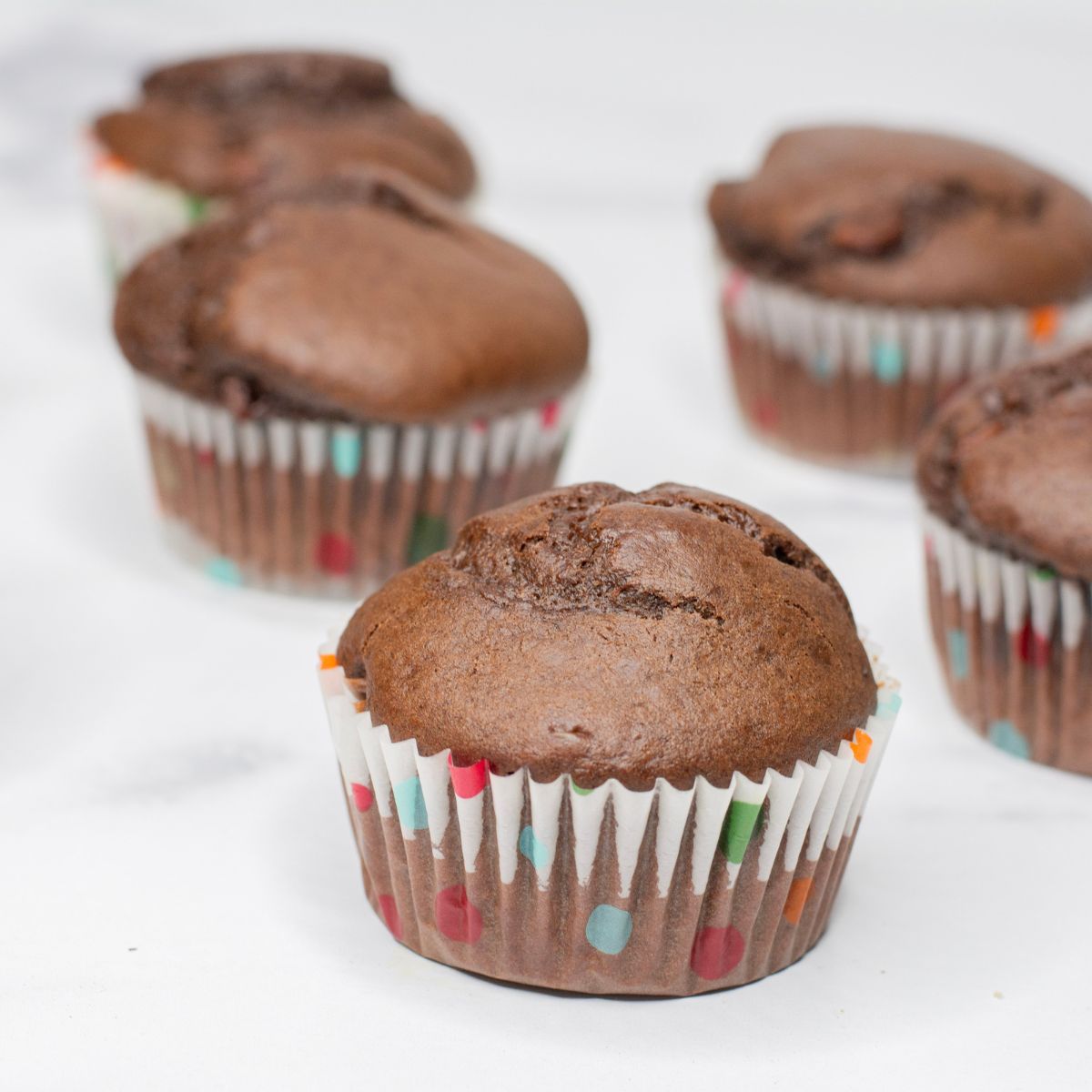 several chocolate muffins on the countertop 