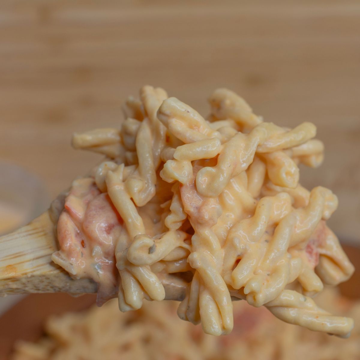Cheesy scoop of pasta on a spoon.
