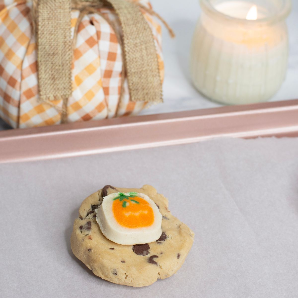 Cookie dough and pumpkin sugar cookie dough on a baking sheet.