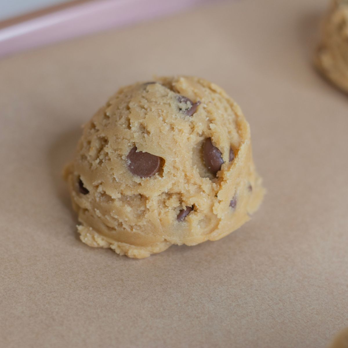 Sourdough discard chocolate chip cookie dough on a cookie sheet.