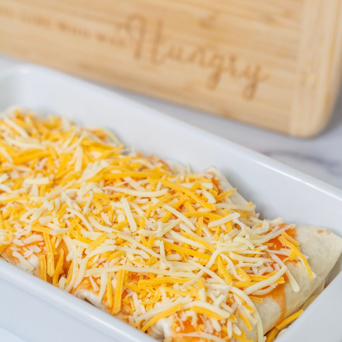 Enchiladas in a pan, not cooked yet.