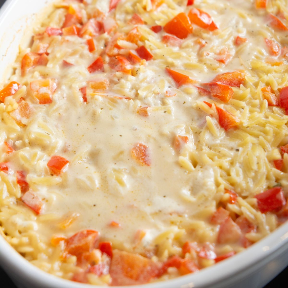 casserole dish with sausage boursin baked orzo pasta in it