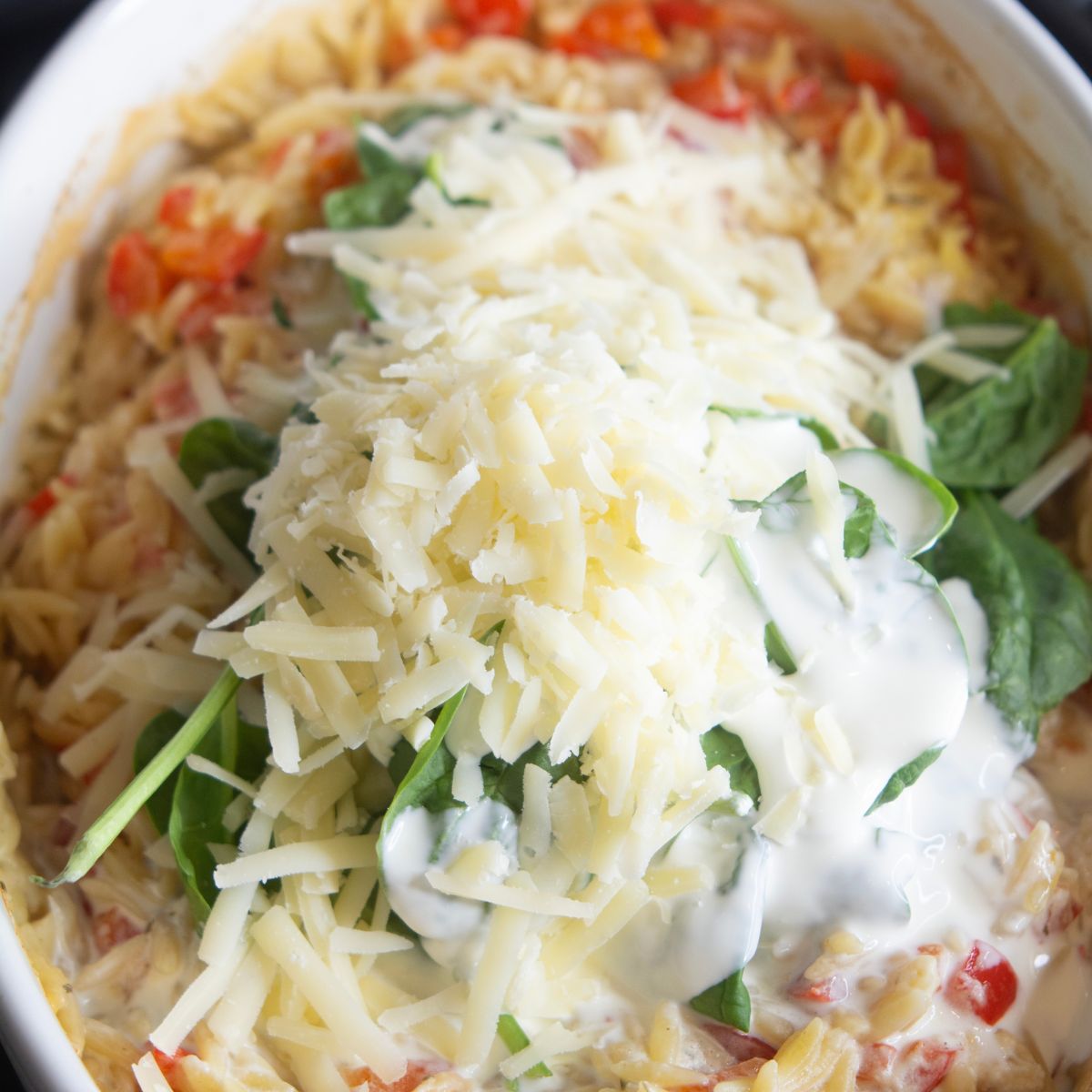 parmesan cheese on top of sausage boursin baked orzo