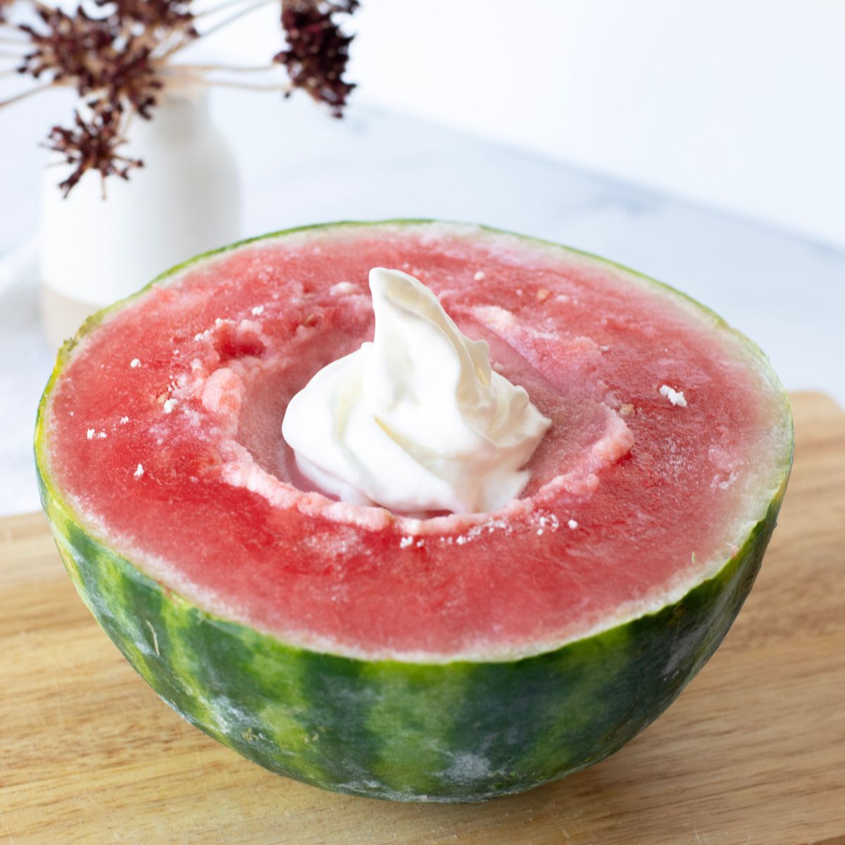 Whipped cream and watermelon ice cream served directly in the watermelon rind.