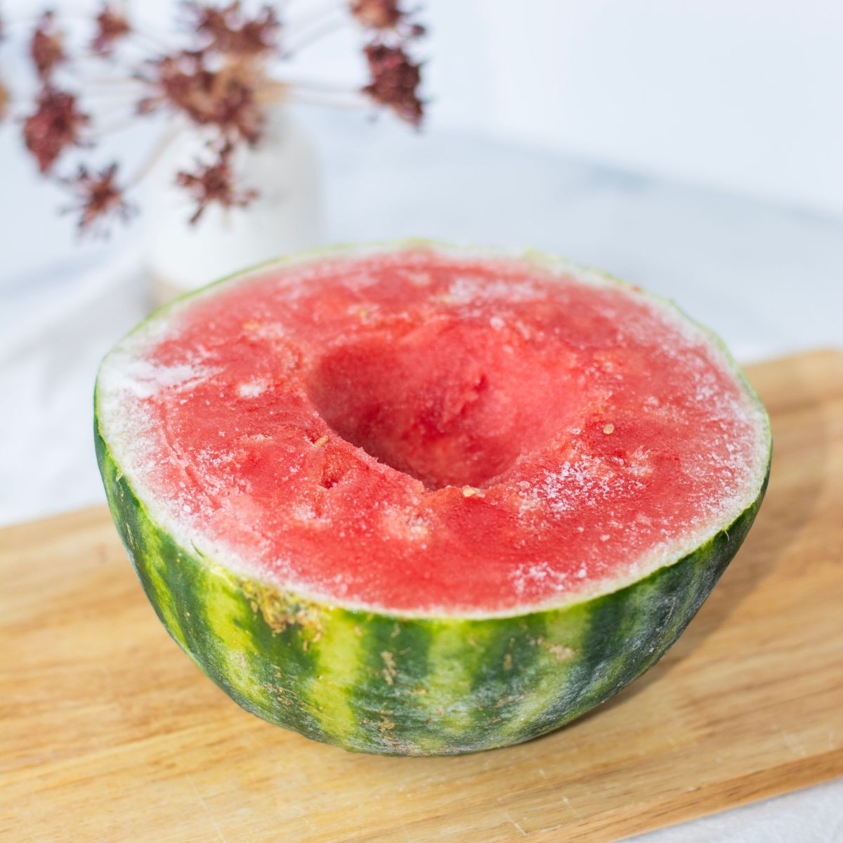 Frozen watermelon cut in half with a big well in the center.