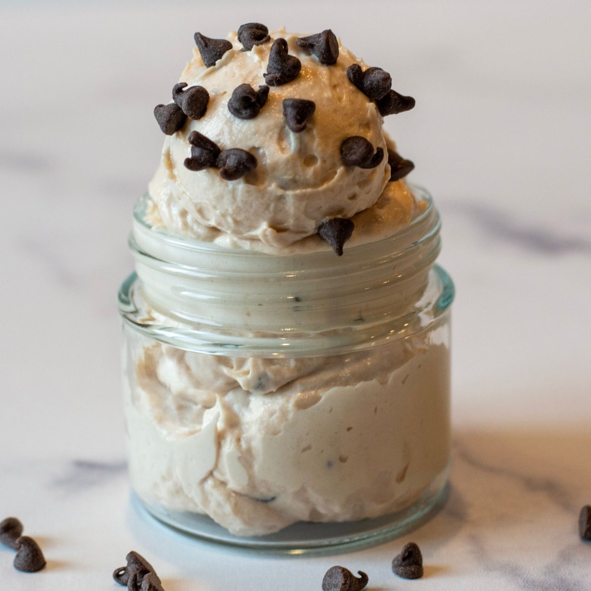 Chocolate chips sprinkled on top of cheesecake yogurt.