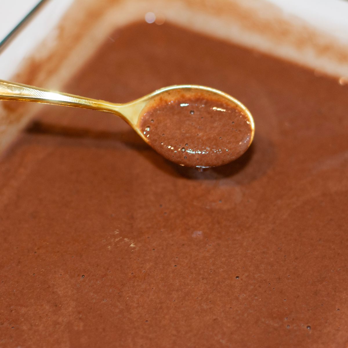 A spoon scooping up pudding