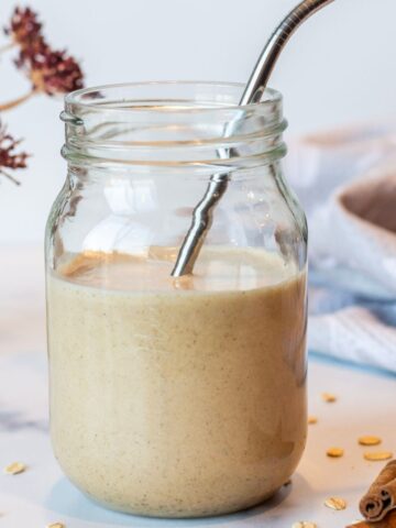 Cookie Dough Date Smoothie in a mason jar with a metal straw