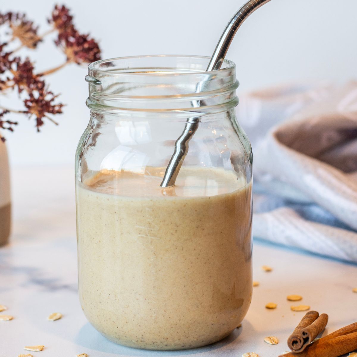 Cookie Dough Date Smoothie in a mason jar with a straw.
