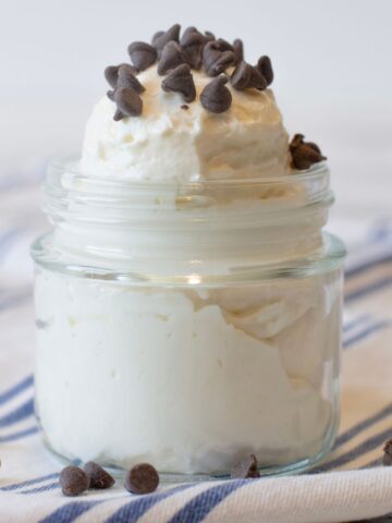 Fluffy protein cheesecake yogurt in a small glass cup-like container